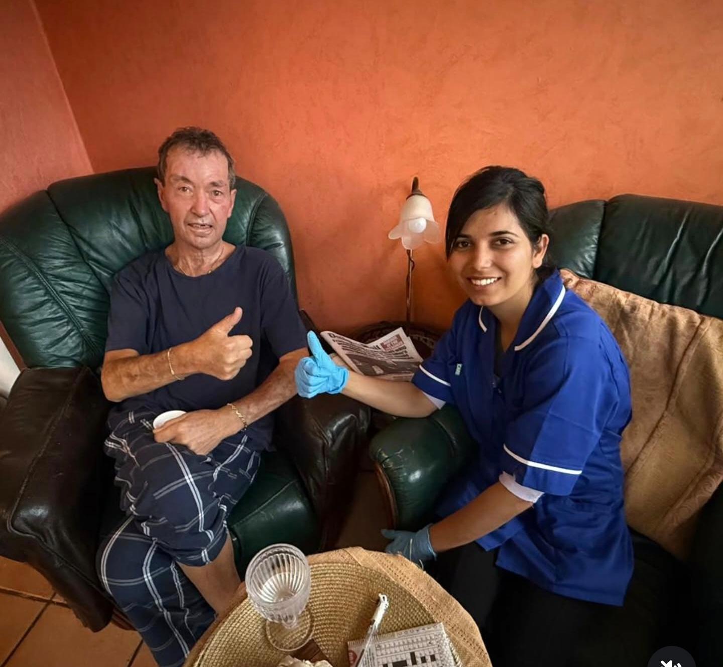 Brancaster Homecare carer reading with a client at home